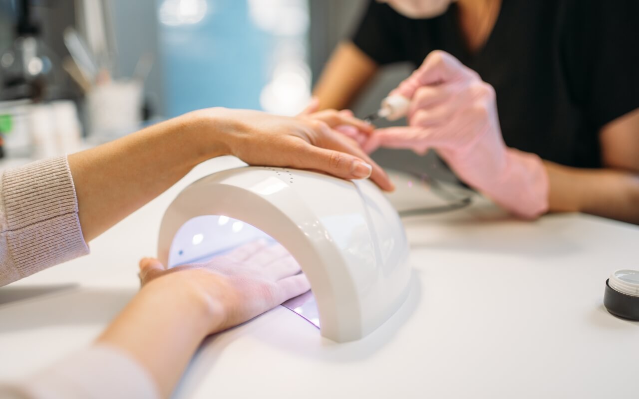 Applying gel extensions for durable Apres nails.